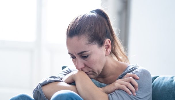 Young,Attractive,Latin,Woman,Lying,At,Home,Living,Room,Couch