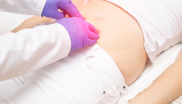 The,Doctor,Probes,The,Lower,Abdomen,In,A,Girl,Who