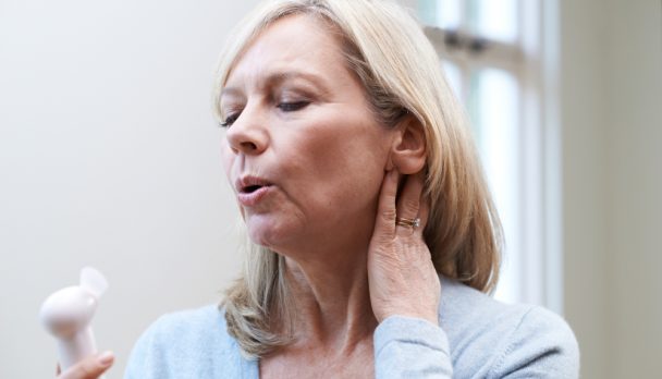 Mature,Woman,Experiencing,Hot,Flush,From,Menopause